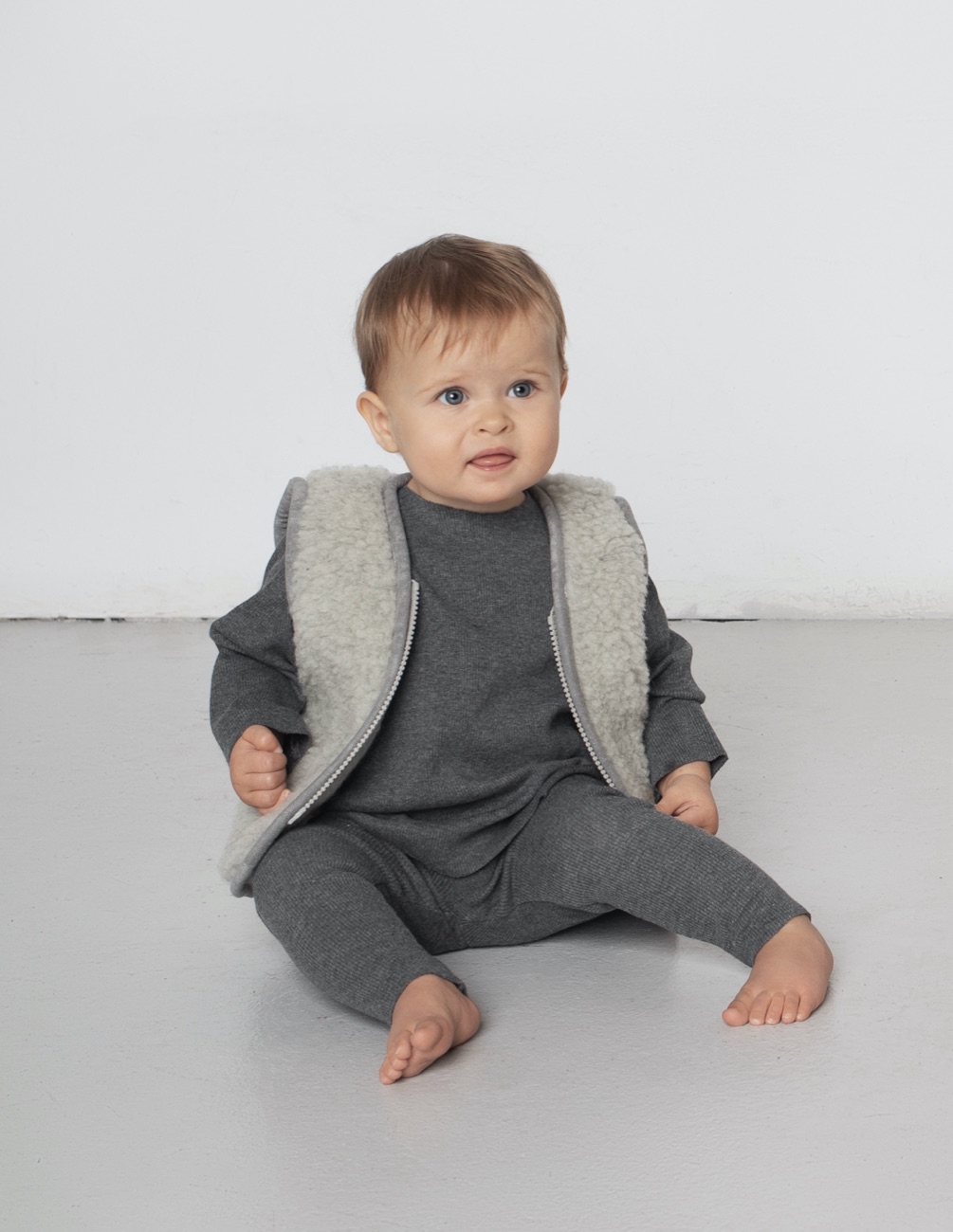 Baby wearing an A Basic Brand sherpa vest